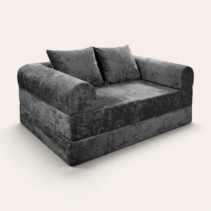 Sofá cama modular Naap Concept color gris oscuro con textura suave y dos cojines, diseño versátil de espuma.