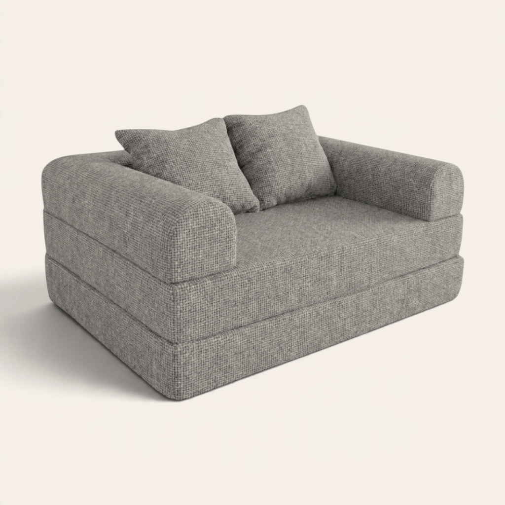 Sofá cama modular Naap Concept Teddy en color gris con textura suave y dos cojines decorativos